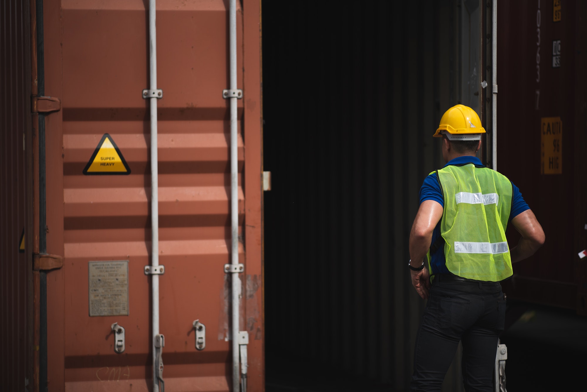 Foreman is opening the container door to inspect the goods inside the container