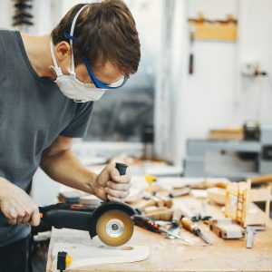 The carpenter works with a tree